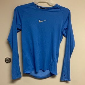 Baby blue Nike running top with thumb slots.